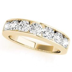 a yellow gold ring with five diamonds on the side, set in 18k gold