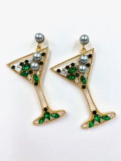 The Misty Martini Earrings are stunning statement earrings, sparkling from top to bottom; these earrings come in champagne gold, Green, and Multi-colour. These are the perfect party, festive, and girls' night out earring that is sure to have everyone asking you about them. Put a smile on your face with these showstoppers! Stud style closure You will receive a spare set of backs for every pair of earrings purchased MOST POPULAR IN STORE 6.2cm x 4.7cm weight 12 g (pair) Elegant Gold Earrings For Holiday, Elegant Gold Earrings For The Holiday Season, Elegant Holiday Dangle Earrings, Party Pearl Earrings In Metal, Party Earrings With Rhinestones, Elegant Metal Pearl Earrings For Parties, Elegant Party Pearl Earrings For Pierced Ears, Elegant Pearl Earrings For Party, Glamorous Metal Jewelry For Party