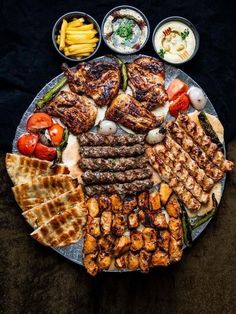 a platter filled with different types of meats and other food items on it