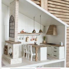 a doll house kitchen with all white furniture and accessories