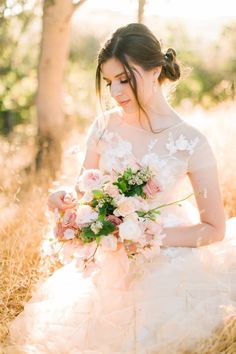 a woman in a wedding dress holding a bouquet