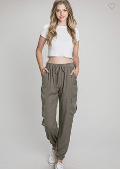 Super trendy silky soft drawstring cargo joggers are a must have for this fall! These olive joggers are perfect to dress up or down for any event this fall season. These are 100% Polyester for a comfy true to size fit. In Stock and ready to ship Spring Trendy Cargo Pants For Elevated Casual Look, Trendy Fall Cargo Pants For Elevated Casual Wear, Relaxed Fit Cargo Style Joggers For Loungewear, Spring Athleisure Cargo Style Joggers, Spring Athleisure Cargo Joggers, Olive Utility Cargo Pants For Spring, Spring Cargo Style Relaxed Fit Joggers, Spring Utility Joggers With Elastic Waistband, Spring Utility Joggers With Side Pockets