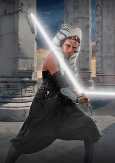 a woman dressed as darth vader holding a light saber in front of some pillars