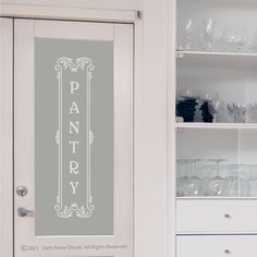 a pantry door with the words pantry on it and glassware in front of it