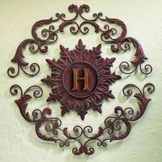 a decorative wall hanging with the letter h on it