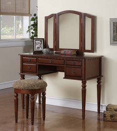 a wooden desk with a mirror and stool