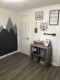 a room with mountains painted on the wall and other items in front of the door