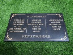 a plaque on the grass that says in loving memory