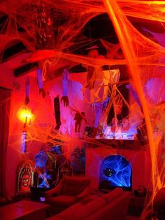 a living room decorated for halloween with spider webs