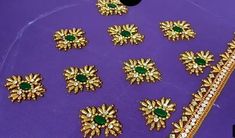 a purple table topped with lots of gold jewelry