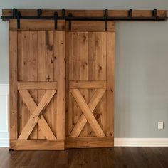 two wooden sliding doors in an empty room