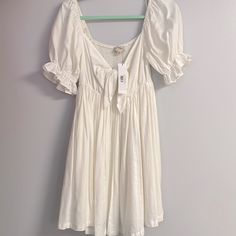 Mable White Babydoll Dress. Knee Length. Excellent Condition, Never Worn. White Casual Peasant Dress For Spring, Cute Off White Summer Dress, Flowy Mini Dress With Tie Back For Daywear, Casual White Peasant Dress For Daywear, White Casual Peasant Dress, White Tie Back Dresses For Daytime, Cute White Flowy Sundress, White Short Sleeve Feminine Sundress, Cute Off-white Spring Dress