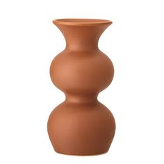 a brown vase sitting on top of a white table