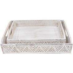 two white trays sitting on top of each other, one with an intricate design