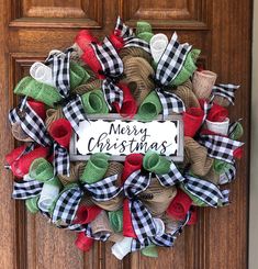 a christmas wreath on the front door is decorated with burlucks and ribbon