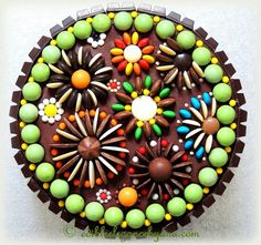 a chocolate cake decorated with colorful candies and decorations