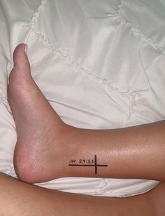 a person with a cross tattoo on their left leg and the words let it be