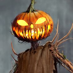 a lighted pumpkin sitting on top of a sack with branches around it and eyes glowing