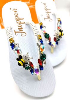 Description The beautiful rhinestone and customizable Flip Flops for the beach brides, bridesmaids, vacation, honeymoon or any occasion you desire to look gorgeous. Perfect in any outfit! Being unique and stunning on design, these flip flops must be your must-have item! The sandal is anti-slip, comfortable and durable as it is made from high quality rubber from the South of Thailand, where is famous for the best rubber tree. Moreover, the crystals are decorated on the sandal with effective adhes Adjustable Sandals With Rhinestones For Beach Season, Adjustable Rhinestone Sandals For Beach Season, Bedazzled Silver Sandals For The Beach, Bedazzled Sandals For Summer Beach, Bedazzled Sandals For Beach In Summer, Silver Bedazzled Sandals For Beach, Silver Bedazzled Sandals For The Beach, Summer Bedazzled Sandals For Beach, Beaded Flip Flops For Summer Party