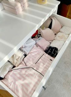 an open drawer with clothes in it