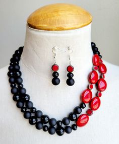 Make a real statement with this OOAK colorful necklace set. Both vintage and new glass beads, Czech glass beads, and marbled red resin beads in hues of shiny black, matte black, and dark red are strung onto 2 wires in this offset design at varying lengths. Necklace is finished with decorative silver bead caps and a large lobster clasp.  The necklace measures 19 inches long with a chain measuring 2 inches included for comfort.  Matching beaded drop earrings are hung on 925 silver ear wires. Black Glass Round Bead Jewelry, Black Glass Round Beads Jewelry, Black Glass Jewelry With Large Beads, Colorful Beads Resin Jewelry Gift, Black Glass Beaded Jewelry, Colorful Round Beaded Resin Jewelry, Adjustable Black Czech Glass Jewelry, Black Glass Polished Beads Jewelry, Black Glass Jewelry With Polished Beads