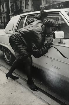 a woman leaning out the window of a car