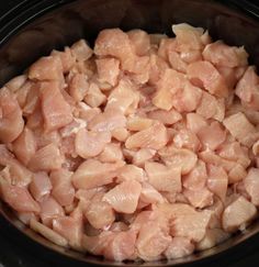 raw chicken in the crock pot ready to be cooked