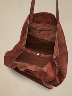 Wider than it is tall, this East-West tote fits most laptops up to 15" and is crafted in soft, sturdy suede with a special zip pocket to keep small items handy.  Open top (no closure).  Two interior slip pockets.  One interior zip pocket.  Unlined. Everyday Suede Shoulder Bag With Zipper Closure, Suede Satchel With Zipper Closure, On-the-go Suede Shoulder Bag With Suede Lining, Brown Suede Travel Bag, Suede Shoulder Bag With Removable Pouch For Travel, Travel Suede Shoulder Bag With Removable Pouch, Suede Bag With Removable Pouch For Everyday, On-the-go Suede Shoulder Bag, Suede Shoulder Bag For On-the-go