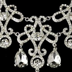 Vintage%20Inspired%20Bridal%20Necklace%20and%20Chandelier%20Earrings%0D%0AAdd%20vintage%20glam%20to%20your%20wedding%20day%20look%20with%20this%20fabulous%20jewelry%20set.%20This%20silver%20plated%20necklace%20and%20chandelier%20earring%20set%20features%20an%20intricate%20scroll%20design%20encrusted%20with%20glistening%20rhinestone%20crystals.%20This%20glamorous%20set%20will%20add%20head-turning%20style%20to%20your%20bridal%20ensemble!%0D%0ASize%3A%20The%20necklace%20is%2014%201%2F2%22%20in%20long%20with%20a%202%22%20extender%2C%20and%20is%202%201%2F2%22%20at%20its%20widest%20point.%20The%20pierced%20chandelier%20earrings%20are%202%22%20long.%0D%0AColor%3A%20Silver.%0D%0AStyle%3A%20ne8387.%0D%0APerfect%20for%20Your%20Modern%20Vintage%20Wedding%20or%20your%20Quinceanera%20celebration!%0D%0A Quinceanera Necklace, Swarovski Tiara, Wedding Necklace Set, Crystal Wedding Jewelry, Jewelry Gift Guide, David Tutera, Crystal Statement Necklace, Silver Wedding Jewelry, Bridal Fashion Jewelry