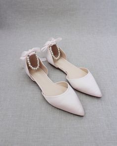 "Satin pointy toe flats with beautiful row of pearls as ankle strap. Comfortable throughout your special day and perfect for holiday party, night out and wedding party. YOU CAN CHOOSE THE PEARLS ANKLE STRAP AT CHECKOUT Details: COLORS AVAILABLE: Black, Blush, Burgundy, Champagne, Light Blue, Navy, Red, Royal Blue, Ivory, and White UPPER: Synthetic upper and lining MATERIALS: Mandmade outsole STYLE NAME: BELLA SIZE FIT: RUNS LARGE, ORDER HALF SIZE DOWN FROM YOUR NORMAL SIZE Not sure of which size Blush Bridal Shoes, Blush Pink Shoes, Blush Shoes, Pink Wedding Shoes, Women's Slip Ons, Black Blush, Pointy Toe Flats, Stunning Shoes, Bridesmaid Shoes