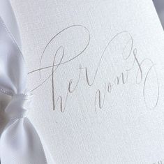 a close up of a wedding guest book with the word, her vows written on it