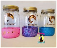 three glass jars with different colored glitters in them and one has a dog on the lid