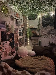 a bedroom with lots of pictures and lights on the wall above the bedspread