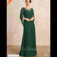 a woman in a long green dress with sheer sleeves and lace detailing on the shoulders