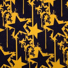 yellow stars on black background with drops of paint coming from them and dripping down the middle