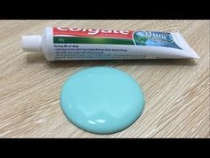 a tube of toothpaste sitting on top of a wooden table