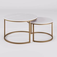 two tables with white marble top and gold metal bases, one on each side by the other