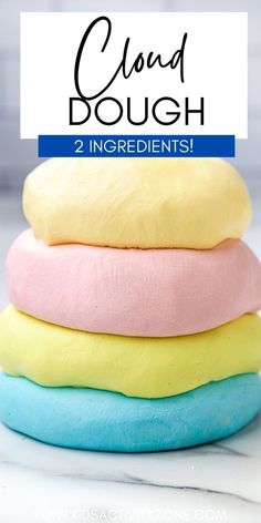 four colorful doughnuts stacked on top of each other with the words cloud dough 2 ingredients