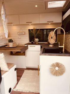 a kitchen area with sink, dishwasher and microwave in it's center