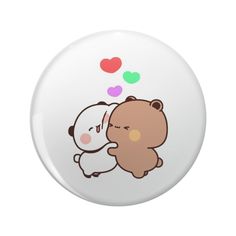 a white button with a brown bear hugging it's head on the other side