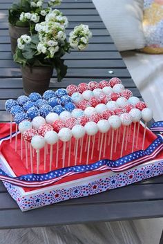 red, white and blue cake pops on a tray