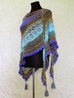 a crocheted shawl on a mannequin