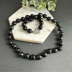 This Stunning Piece Is Hand Knotted And Features Faceted Natural Stones That Catch The Light Beautifully. The Black Onyx Beads Are Sleek And Sophisticated, Making This Necklace Perfect For Dressing Up Any Outfit. Whether You're Heading To A Fancy Event Or Just Want To Add Some Glam To Your Everyday Look, This Necklace Is Sure To Do The Trick. So Why Wait? Treat Yourself To This Gorgeous Piece Today! 10mm Faceted Black Onyx. Stainless Steel Sailor Clasp, Removable Pendant Can Be Added. Elegant Black Crystal Necklace With Gemstone Beads, Black Crystal Necklace With Natural Stones, Formal Onyx Round Bead Necklaces, Formal Onyx Necklace With Round Beads, Black Necklaces With Round Natural Stones, Elegant Adjustable Black Crystal Necklace, Black Faceted Crystal Necklace Elegant Style, Formal Onyx Necklace, Elegant Black Faceted Crystal Necklace