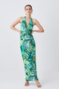 {@@=Ist.Core.Helpers.StringHelper.ToProperCase("A quintessential summer piece, this maxi dress exudes a playful-yet-elegant aesthetic. This piece is enriched with vibrant hues and a palm print. A ruched waist creates a flattering effect, style this piece with sandals or heels for a holiday-ready ensemble.Palm printRuched fabricMaxi hemlineHalter necklineSleeveless designExpertly designed for those 5'3" and under, our Petite pieces are perfectly proportioned for a smaller frame using shorter leng Beachwear Ruched Dress For Beach Party, Beachwear Ruched Dress For Vacation, Ruched Maxi Beachwear Dress, Ruched Dress For Beach Party Season, Ruched Dress For Beach Party, Beachwear Ruched Dresses For Beach Season, Tropical Halter Neck Dresses For Vacation, Tropical Halter Neck Dresses For Summer Parties, Beachwear Dresses With Ruched Detail For Beach Season