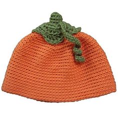 an orange knitted hat with a green crochet bow on the top and bottom