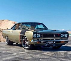 an old muscle car parked in a parking lot