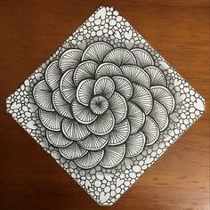 a drawing of a flower on top of a wooden table