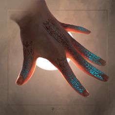 a person's hand with blue and black tattoos on it, lit up by the sun