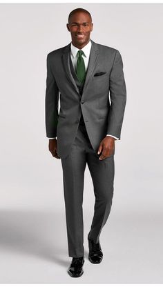 a man in a gray suit and green tie