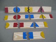 several pieces of wood that have been cut into shapes with different colors and shapes on them